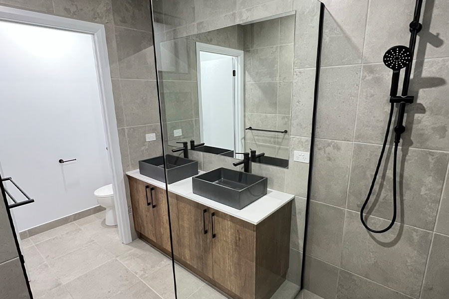stone-tile-bathroom-black-double-vanity